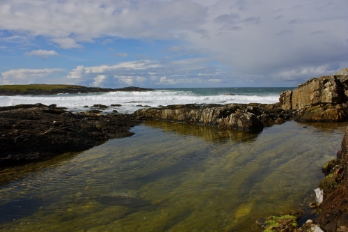 A calm rock pool in the foreground, while the great waves of Hosta close in!